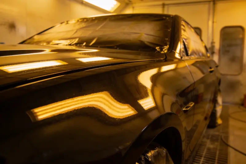 Freshly painted car panel inside a spray booth — ProColor Collision